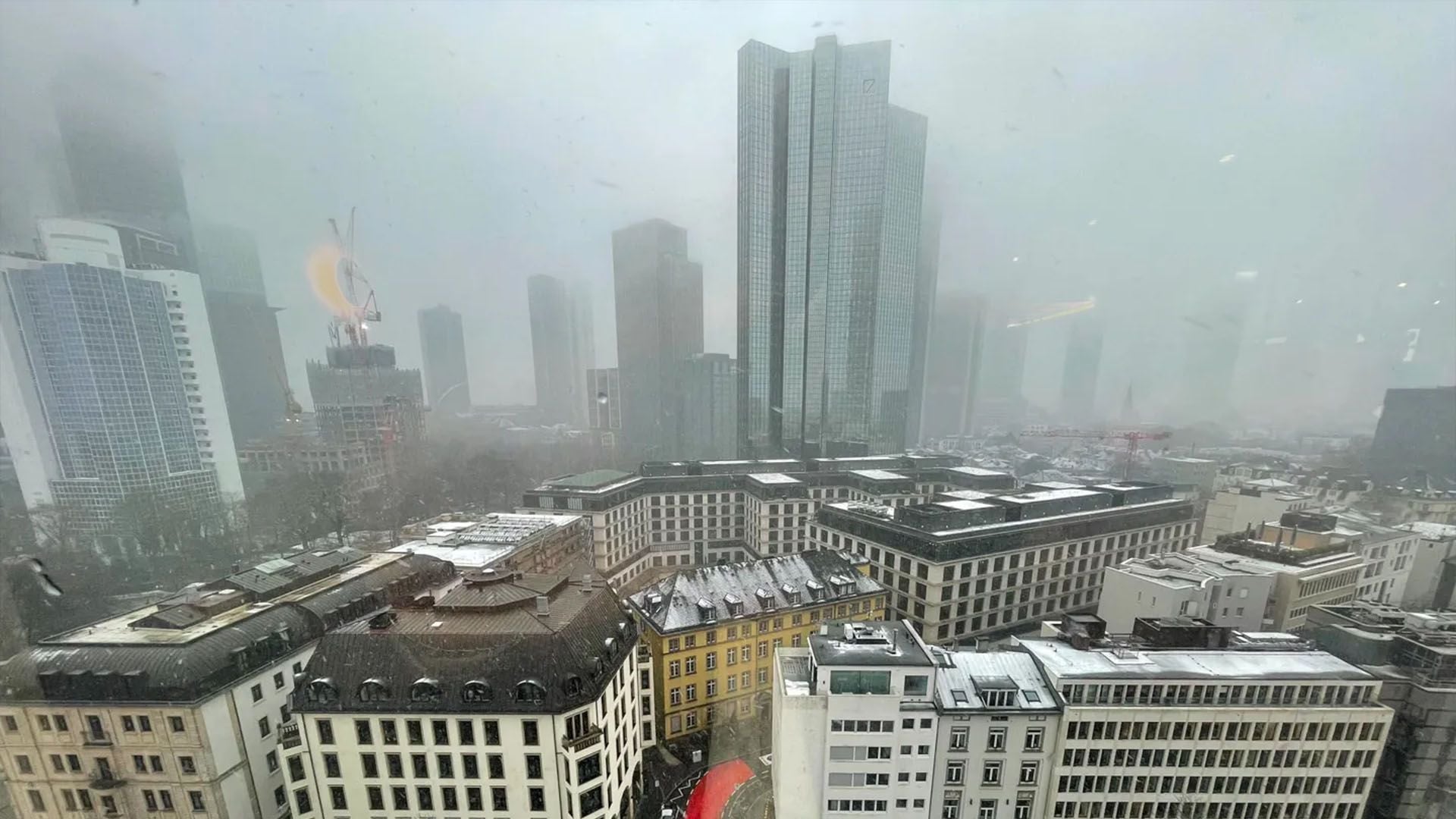 Photograph of the view over Frankfurt from Ardian's office showing buildings on a grey, cloudy day