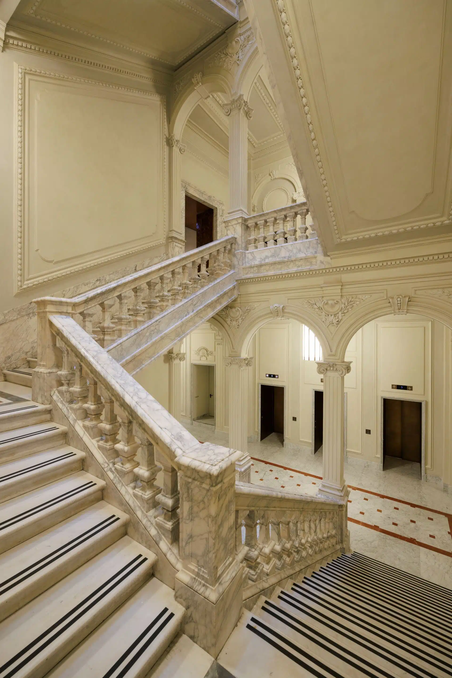 A luxurious guest room in the Orient Express La Minerva, featuring a plush bed with rich textiles and classic decor.