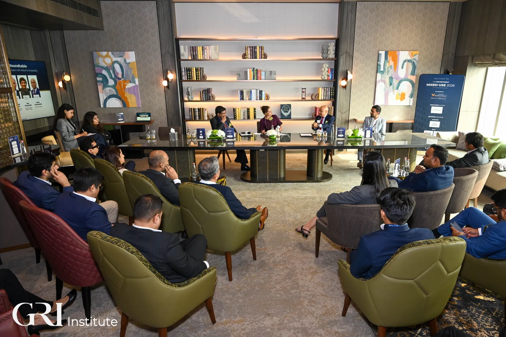 A group of formal-dressed people gathered in front of real estate panellist during GRI Mixed-Use 2026 roundtable