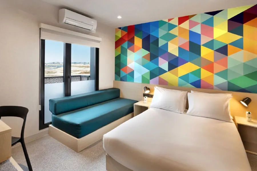 A luxurious guest room in the Orient Express La Minerva, featuring a plush bed with rich textiles and classic decor.