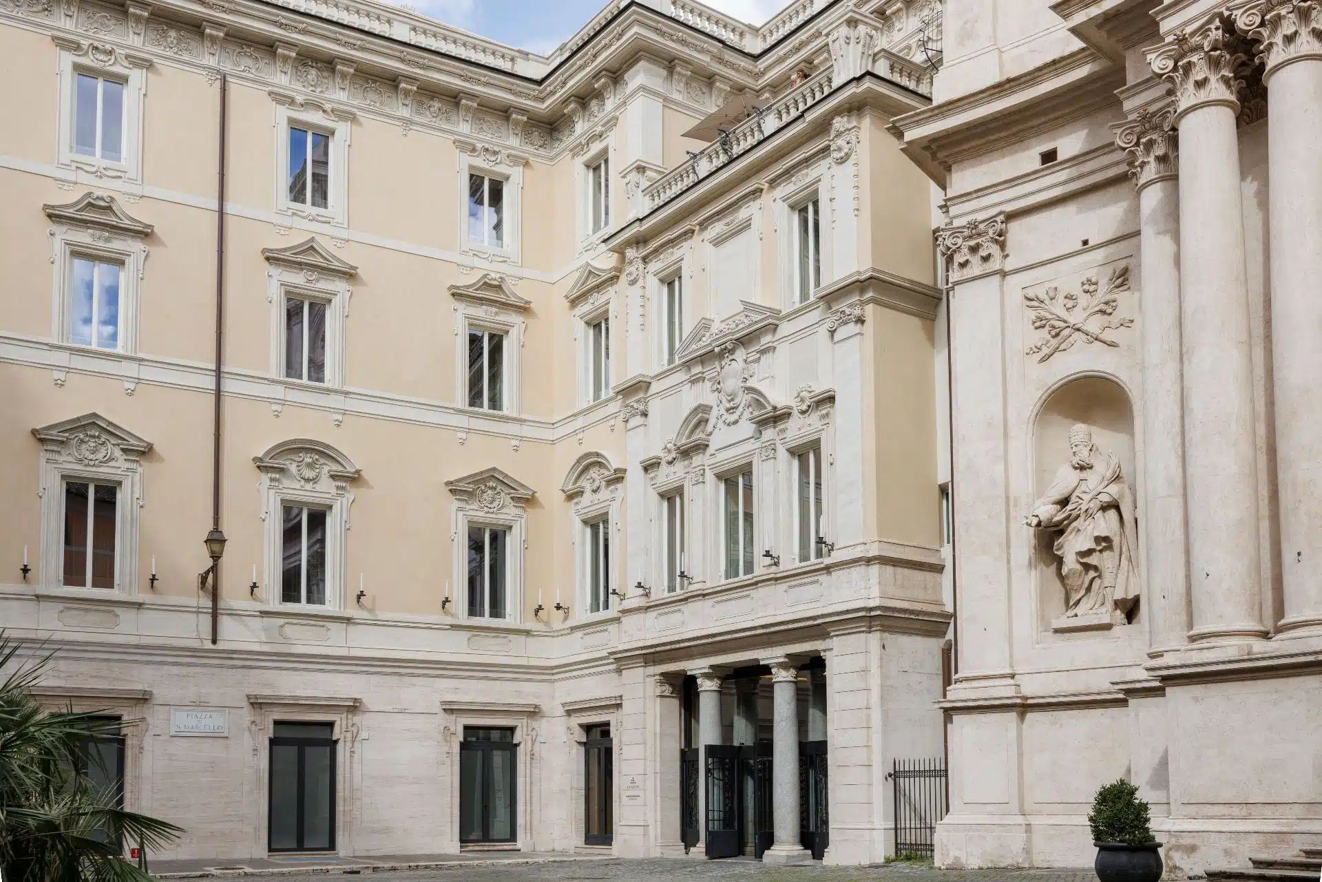 A luxurious marble bathroom in the Orient Express La Minerva, featuring a deep soaking tub, ornate fixtures, and classic design details.