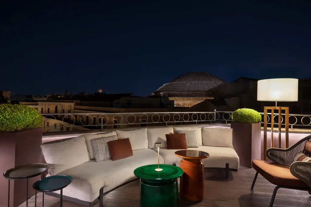 The bar terrace at AK ROMPA hotel, with outdoor seating and a stunning direct view of the historic Pantheon in Rome.