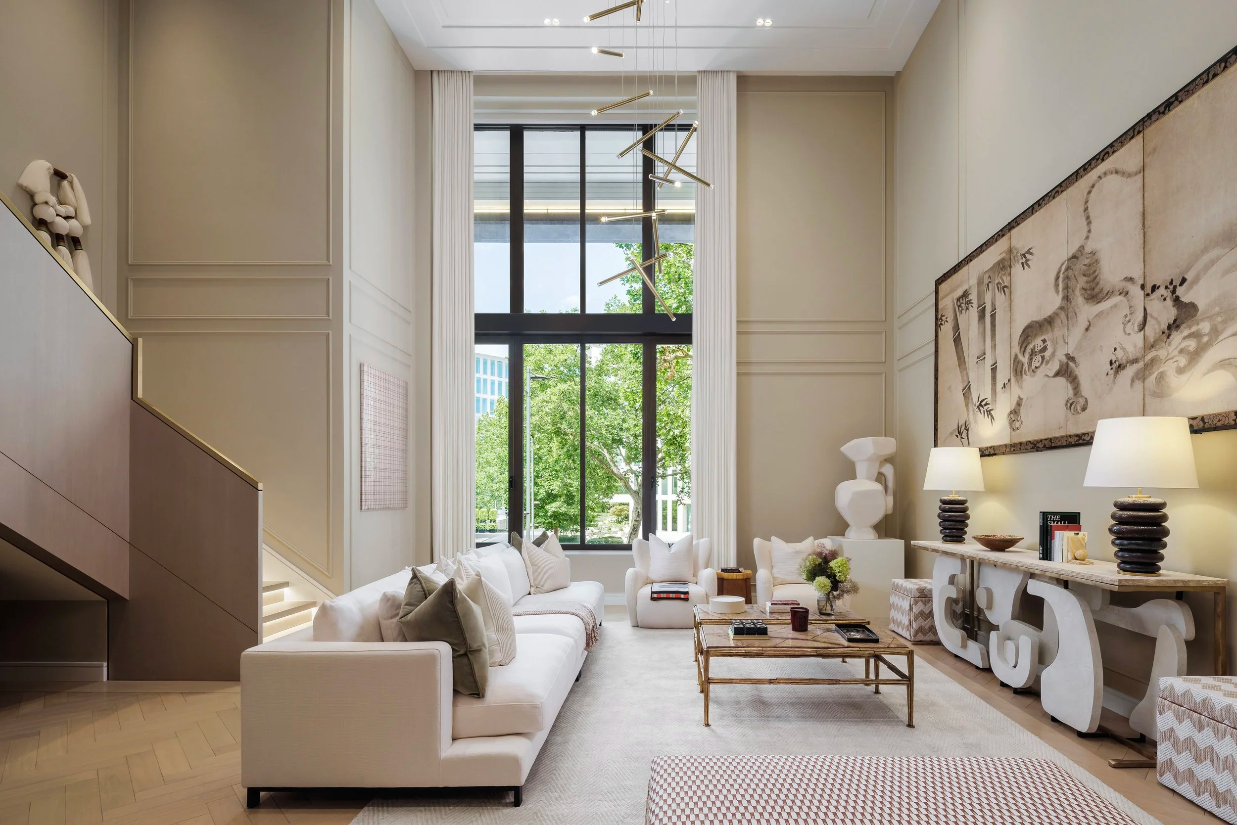 An elegant seating nook in the hotel, with velvet armchairs, a marble table, and dramatic drapery, creating an intimate and luxurious atmosphere.