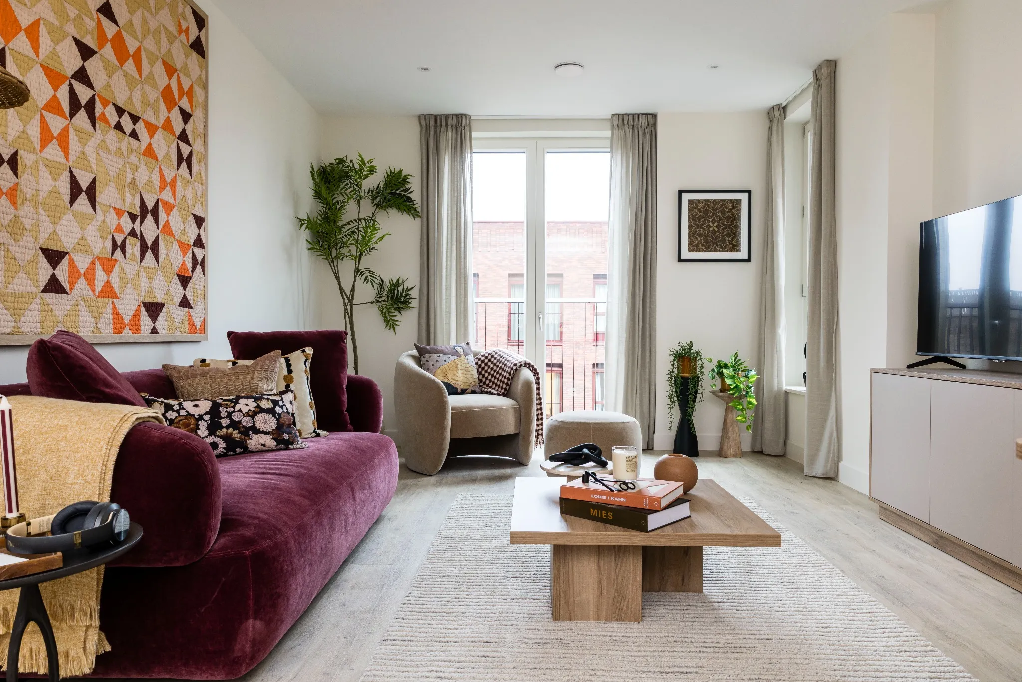 An elegant seating nook in the hotel, with velvet armchairs, a marble table, and dramatic drapery, creating an intimate and luxurious atmosphere.