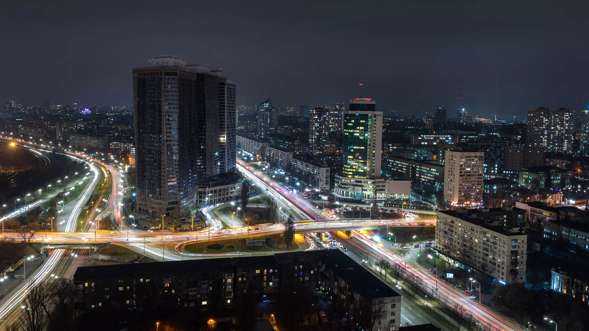 Aerial panoramic drone view of traffic road junction in Kiev, Ukraine at night before the war