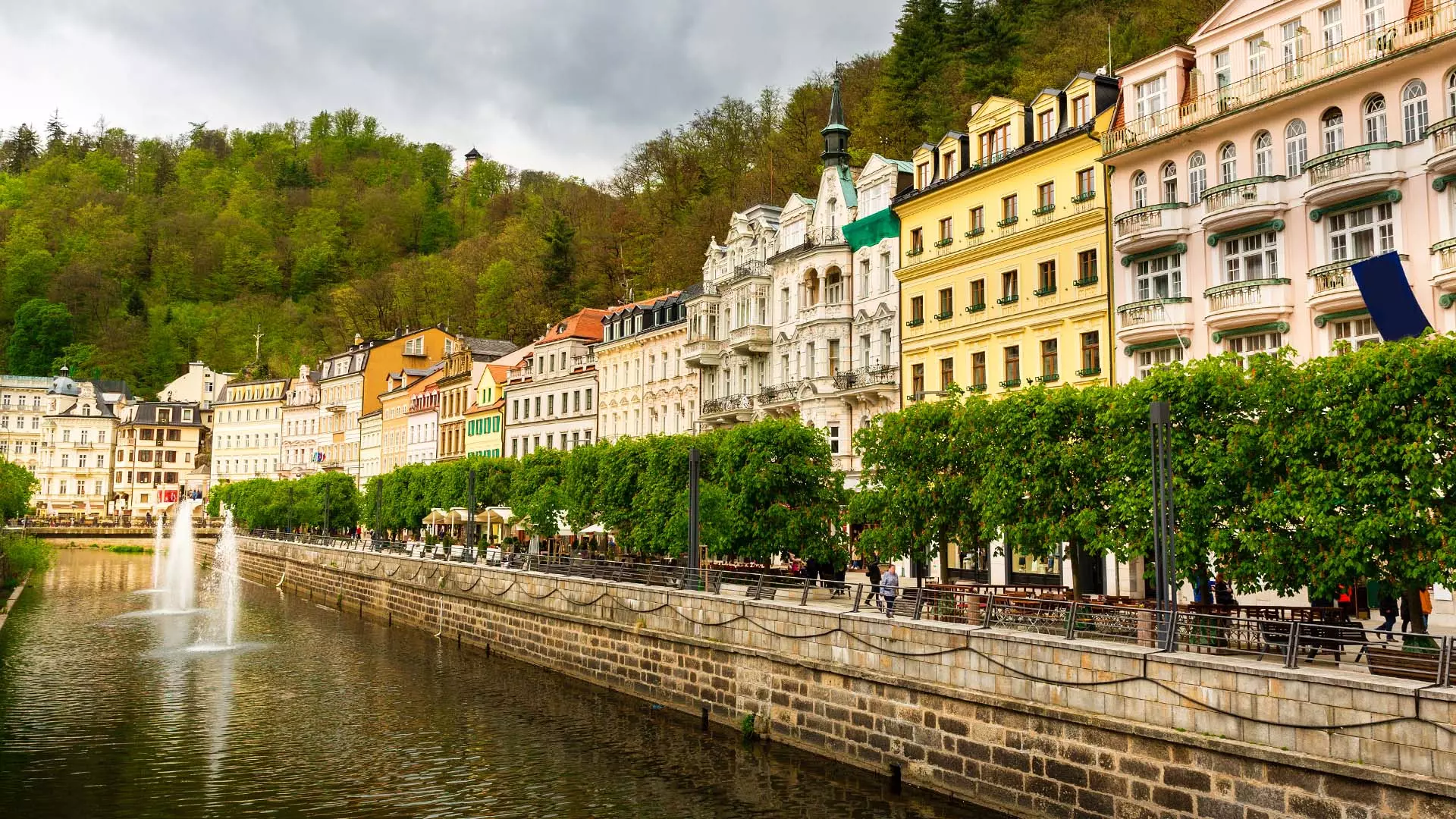 City river and stone pedestrian bridge, Karlovy Vary, Czechia